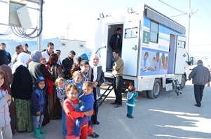 Patients line up outside the clinic waiting for services. Photo: WHO/P Ajello