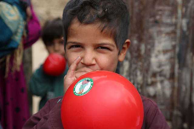 After receiving his polio vaccination, Waris gets a balloon. Loya Wala, Kandahar.