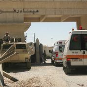 Ambulances from the Palestinian Ministry of Health wait to cross into the Egypt at the Rafah border crossing, the only border through which Palestinians can exit Gaza, in the southern Gaza Strip,10  July 10, 2014. The border crossing was opened on Thursday to evacuate Egyptians stranded in Gaza and Palestinians seriously wounded during Israel's aerial assault in Gaza