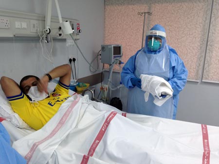 Health care workers in Solimaniyah Hospital in Bahrain conduct a simulation drill to demonstrate handling a suspected case of Ebola Virus Disease