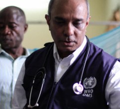 A photo of a WHO health professional wearing a stethoscope around his neck