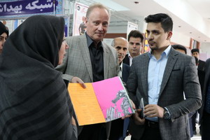 Dr Christoph Hamelmann, WHO Representative in Islamic Republic of Iran, is shown artwork during the exhibition