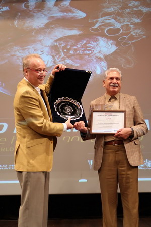 WHO Representative Dr Hamelmann presents the award and certificate to Professor Masjedi