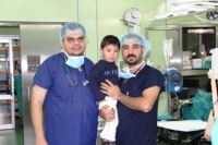 A team of ENT specialists pose for a picture with a child who benefited from the cochlear implant in Duhok. WHO supported to conduct the training of the health workers                                                              