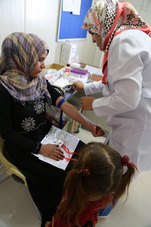 Taking a laboratory test at primary health care centre in Hamam Al Alili supported by health cluster partner
