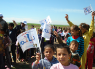 A group of children waving flags celebrating World TB Day