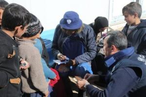 WHO_staff_interviews_Safia_a_lady_displaced_from_Mosul._Standing_next_to_her_are_her_children