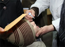 A Syrian child while receiving polio vaccine last week