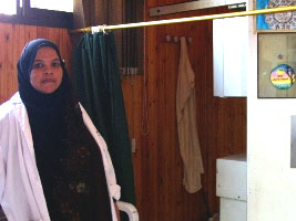 A female nurse standing in front of radiology examination change cubicles