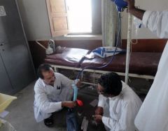 A Disease Early Warning System (DEWS) surveillance officer with the district health office team demonstrate the use of a water filter and provide purification sachets in Kech district following the earthquake