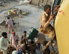 People scrambling to board a rescue plane in Pakistan during the floods of 2010