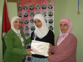 From_left_Dr._Tasneem_Atatrah_First_Prize_winning_student_Ghaida_Ameen_Tmeeze_and_School_Principle_Ghoson_Najar_ From_left_Dr._Tasneem_Atatrah_First_Prize_winning_student_Ghaida_Ameen_Tmeeze_and_School_Principle_Ghoson_Najar_