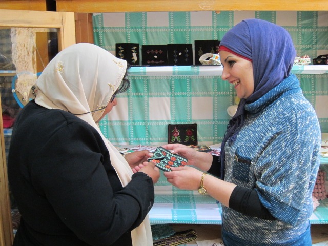 Sama (left) shows Dyala a wallet she has made during occupational therapy