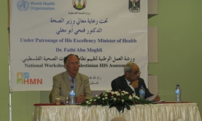 Tony Laurance, WHO Representative for oPt, at a table at teh front of the workshop on assessing health information systems with a representative of the Ministry of Health of oPt