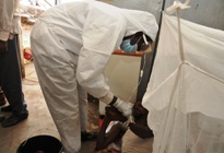 A patient receives treatment from a health staff at the isolation ward of Nyala teaching hospital.