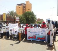 People marching in the street to raise awareness of road safety during Global Road Safety Week