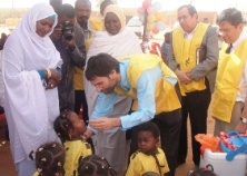 A photo of Dr Anshu Banerjee giving drops to children