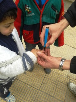 A_young_boy_has_his_finger_marked_after__polio_vaccination