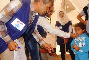 One of the children of IDPs is being diagnosed by a medical team from a WHO's  NGO partner at Al- Bahra camp