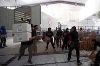 Staff unloading boxes of medicines