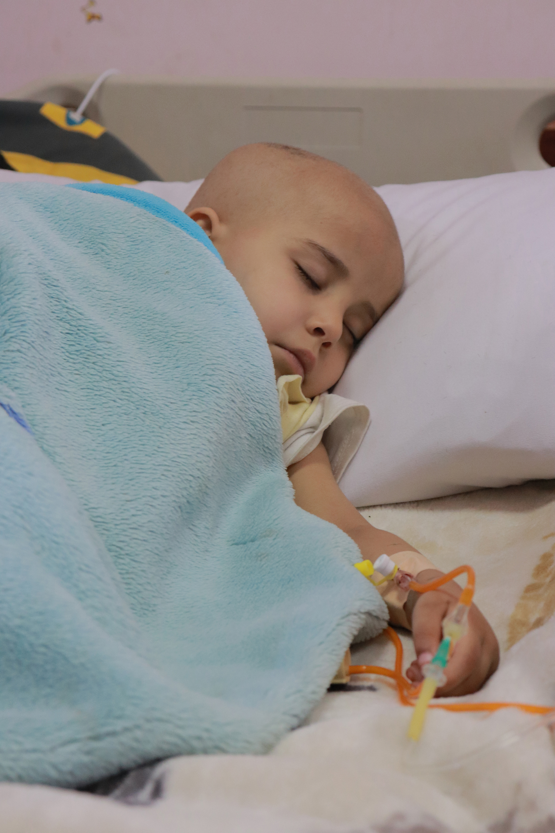 Layan was finally able to sleep after crying from the pain of the cannula that has been attached in her hand for days