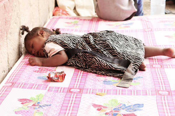 Nada’s daughter is sick and lays on this mattress which she shares with her 3 brothers and sisters and mother. They have to sleep in the school corridor until they get a classroom